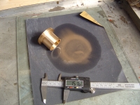  using wet&dry paper on glass to grind down the end of a brass bush to tollerance